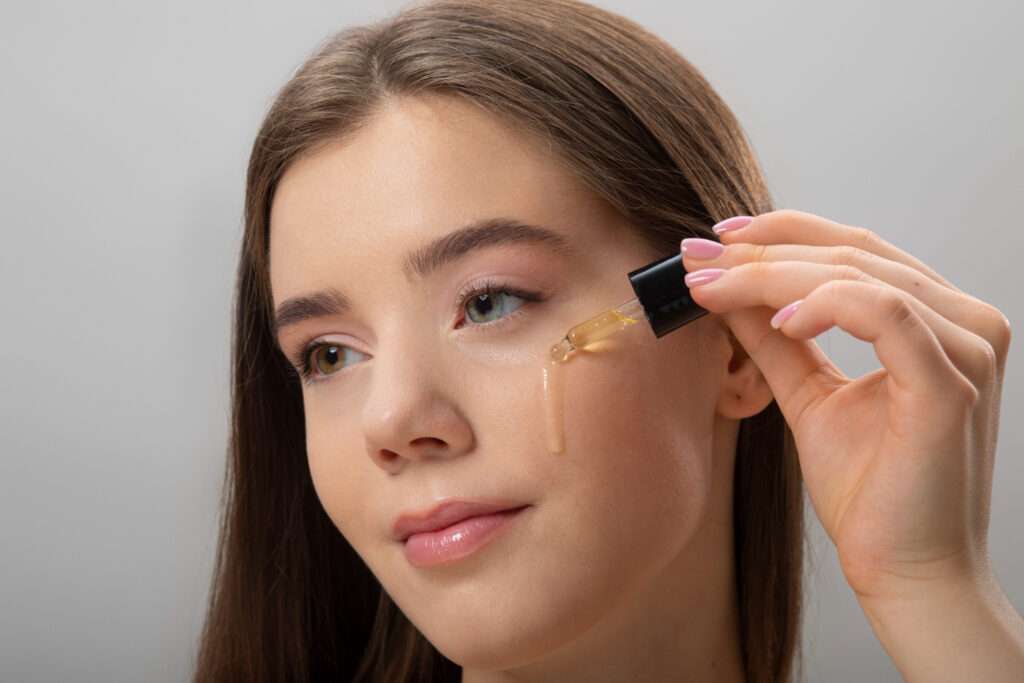 side view woman applying serum